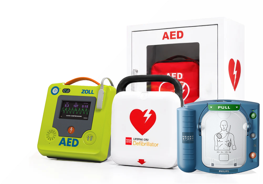 Collection of AEDs in front of a white AED cabinet