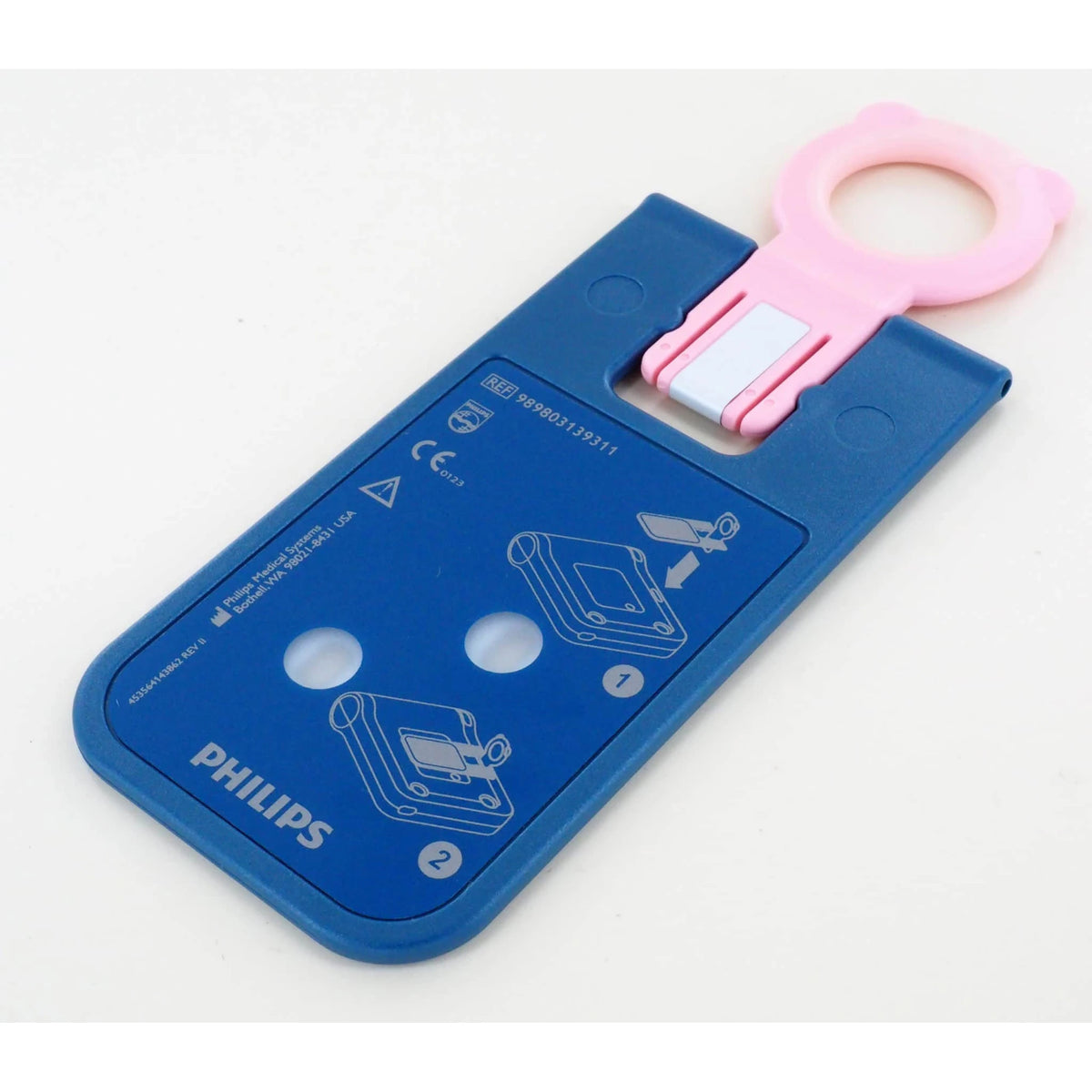 Philips HeartStart FRx Infant/Child Key, angled view showing the pink ring handle and the reverse side with REF 989803139311