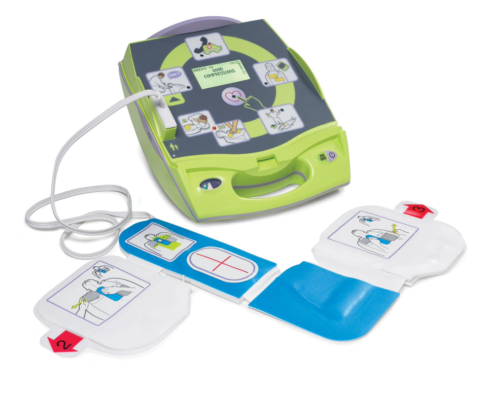 ZOLL AED training device open with instructional pictogram lid and pads laid out