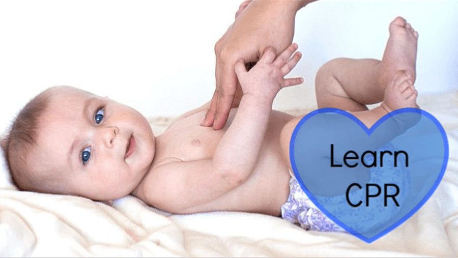 Infant lying on a blanket with an adult's hand gently touching its chest, with a Learn CPR heart graphic