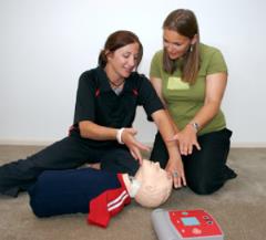 women demonstrating using an aed