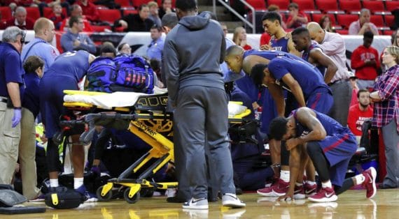 basketball player being taken away on stretcher