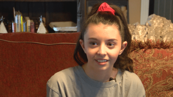 young girl sitting on couch