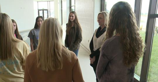 students meeting in school hallway