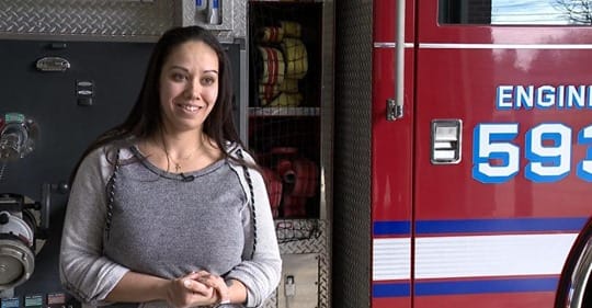 woman in front of fire truck