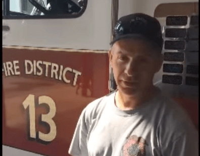 man in front of fire truck