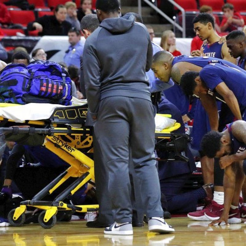 basketball player being taken away on stretcher