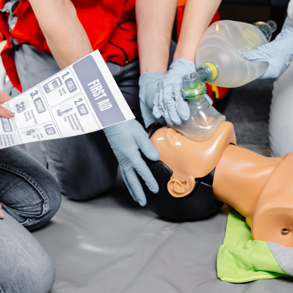 Students preforming CPR on a mannequin during a training class