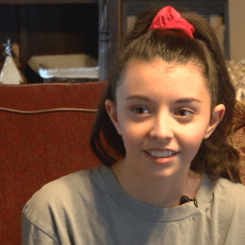 young girl sitting on couch