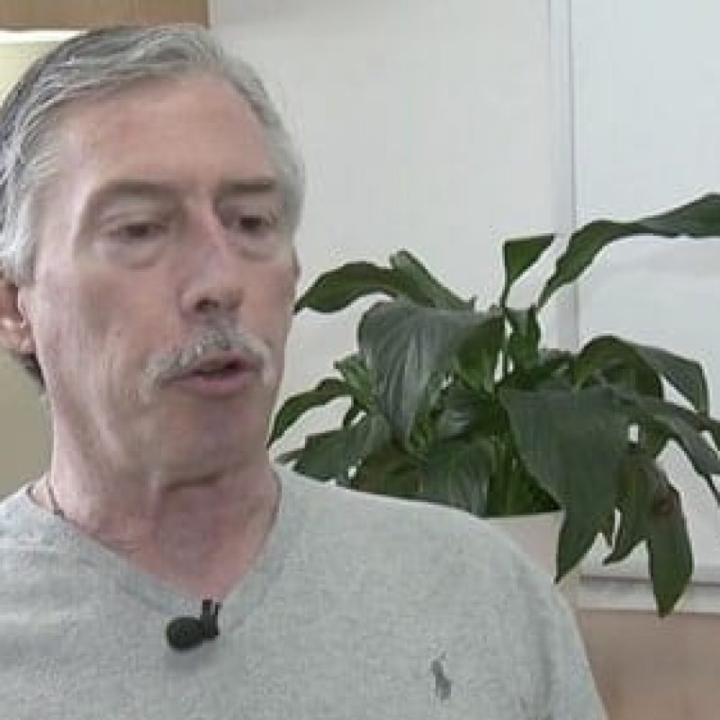 man in front of plant and being interviewed for TV