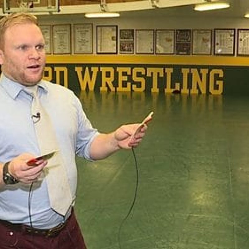 man with aed pads in wrestling room