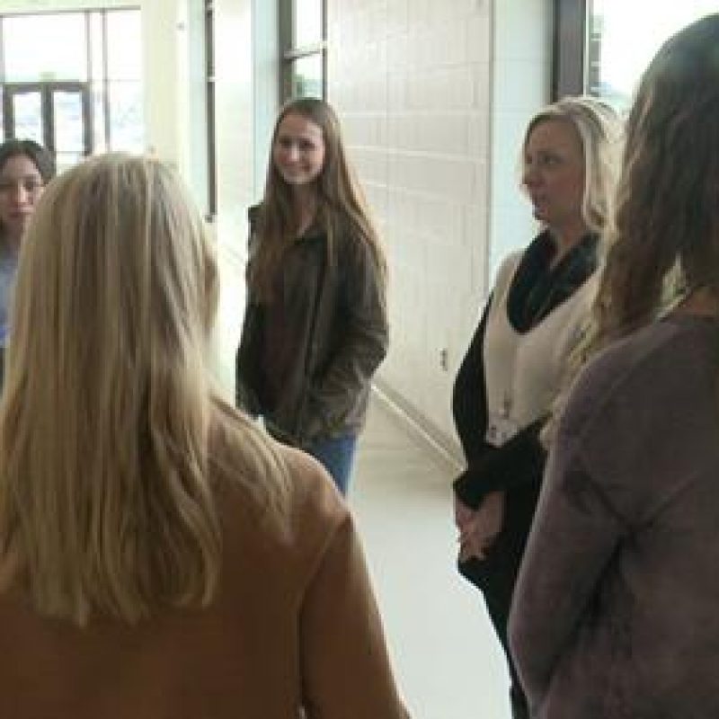 students meeting in school hallway