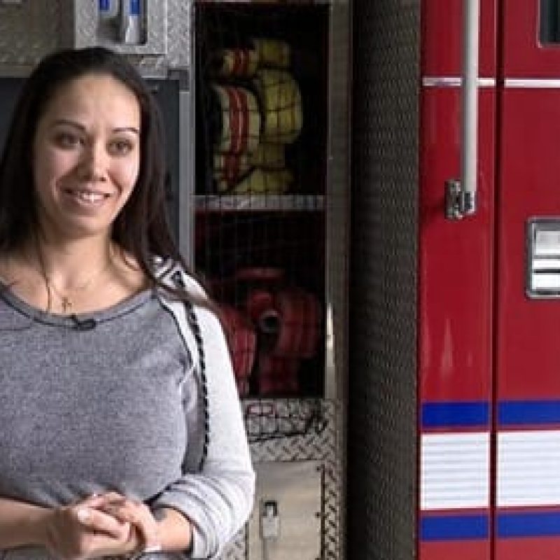 woman in front of fire truck