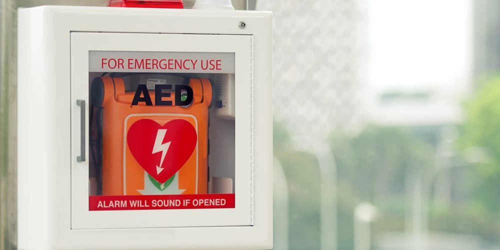 aed mounted to wall in cabinet